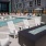 Large sparkling blue pool with a large pool deck and lounge chairs