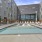 Large sparkling blue pool with a large pool deck and lounge chairs